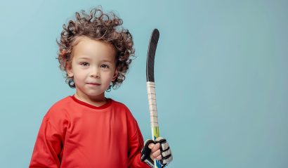 energetic-little-boy-holding-hockey-stick